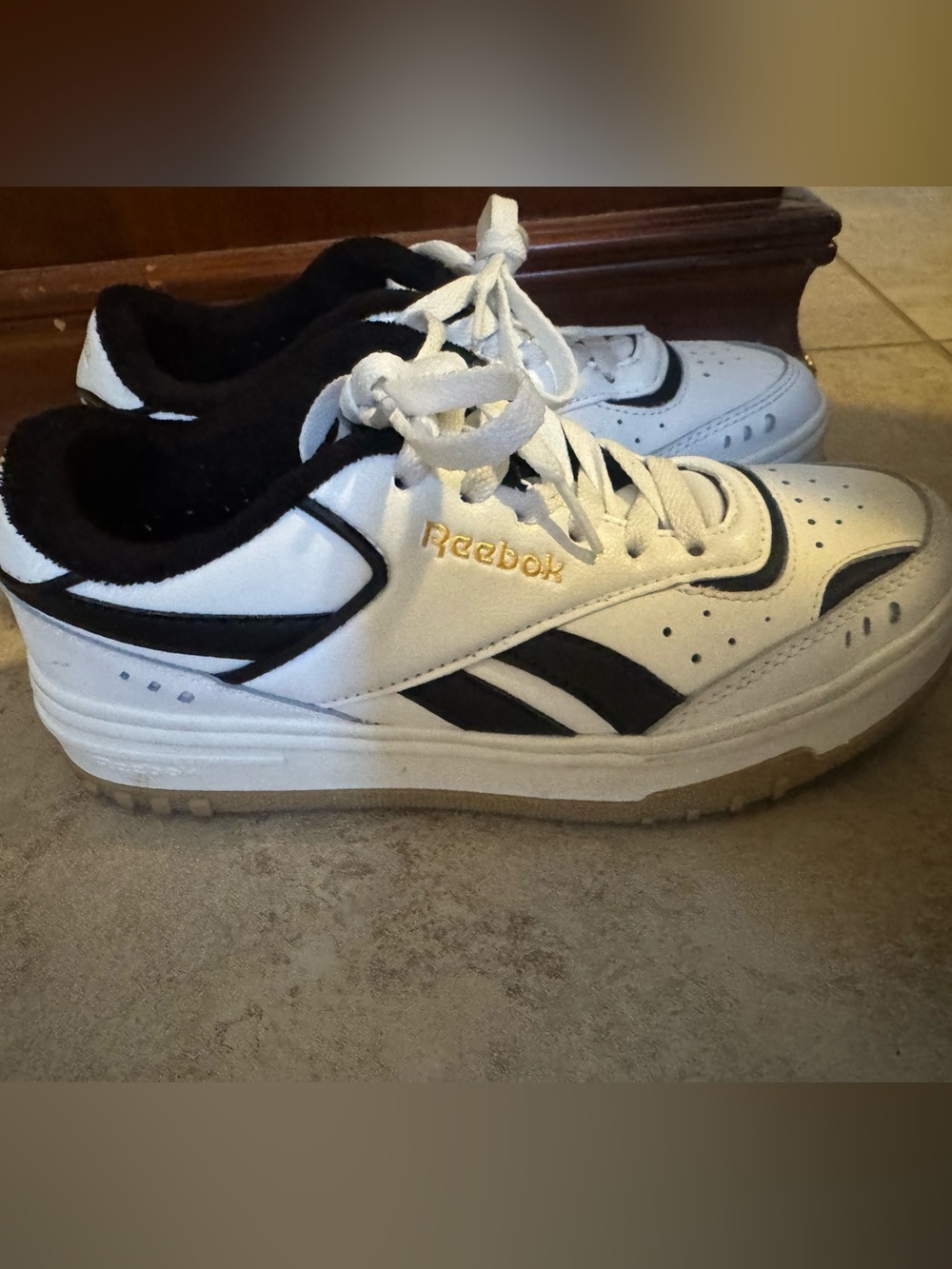 Reebok White Sneakers with Black Accents and Gold Logo